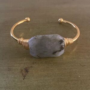 Kinsley Armelle cuff bracelet with gray/green center stone.
